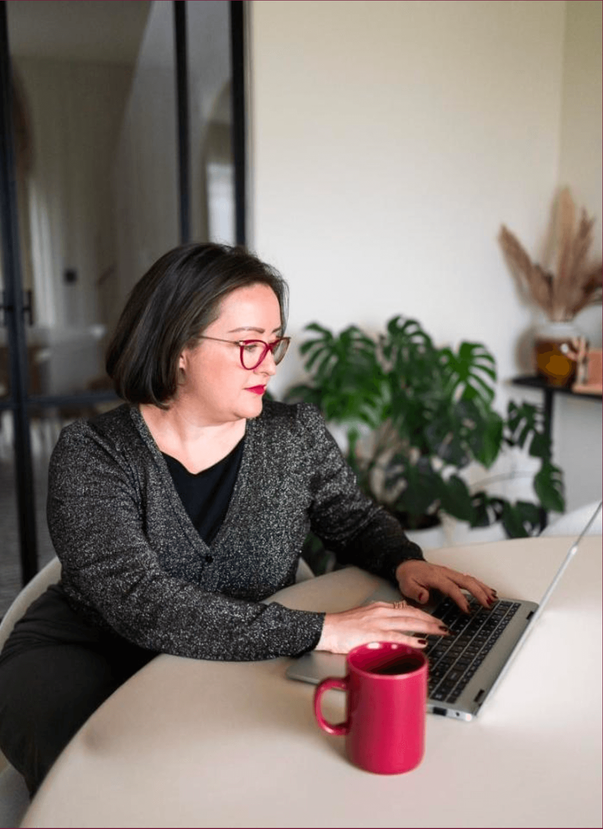 Professional woman working on laptop with coffee